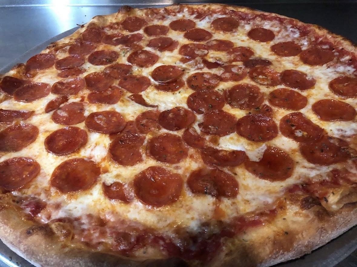 a pepperoni pizza on a pan