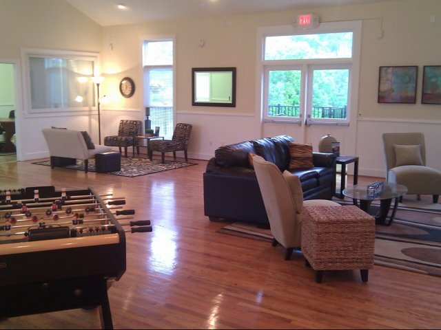 a room with a foosball table and couches